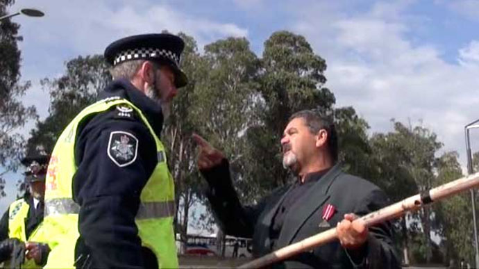 Fred Hooper at the 2015 Frontier Wars March confronts an aggressive member of the Australian Federal Police.