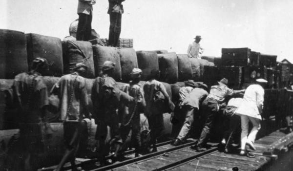Chained aboriginal prisoners on Australia's wharf rail line circa 1920