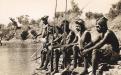 en watch for crocodiles while waiting for a ceremony at Victoria River, NT, in 1952. Arthur Groom / IDIDJ Australia